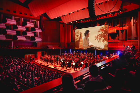 Qing Du performing with the BBC Concert Orchestra at Royal Festival Hall for BAFTA Games in Concert, bringing the guzheng into orchestral and cinematic music settings.